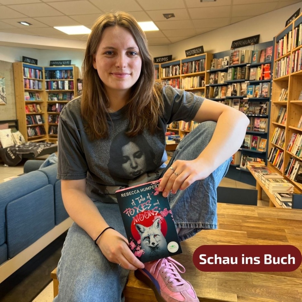 Unsere Buchhändlerin hält das Buch "A Tale of Foxes and Moons" von Rebecca Humpert in der Hand, zu dem sie eine Rezension geschrieben hat. Außerdem gibt es die Möglichkeit für eine Leseprobe.